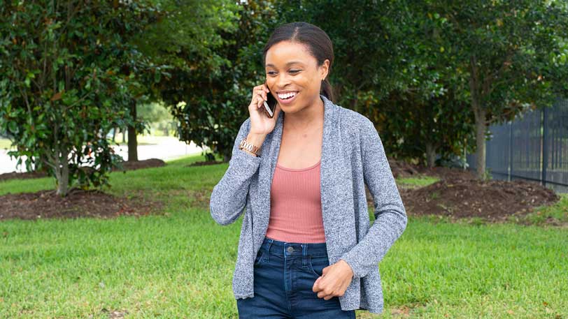 A woman outside talking on the phone